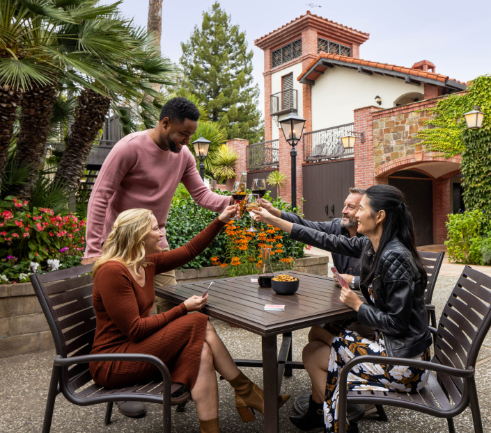 Roman Spa Hospitality and Lifestyle Photography Roman Spa cheers at a table outside - architectural and lifestyle photographer Calistoga